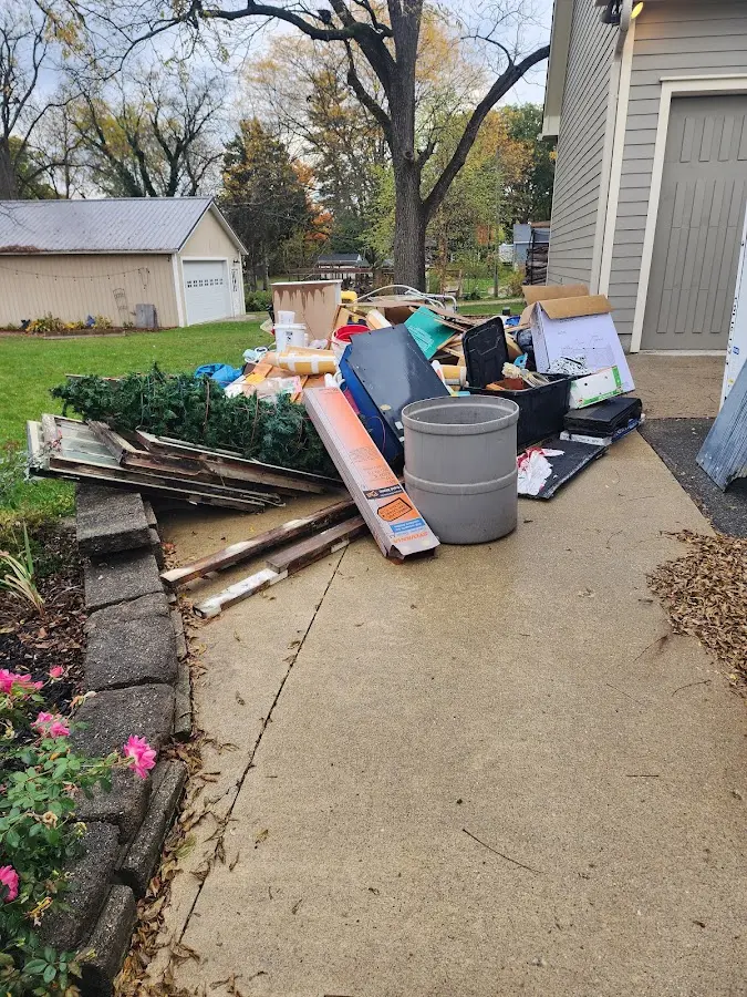 Dumpster being loaded with debris for Estate Cleanout Dumpster Rental in Clemmons